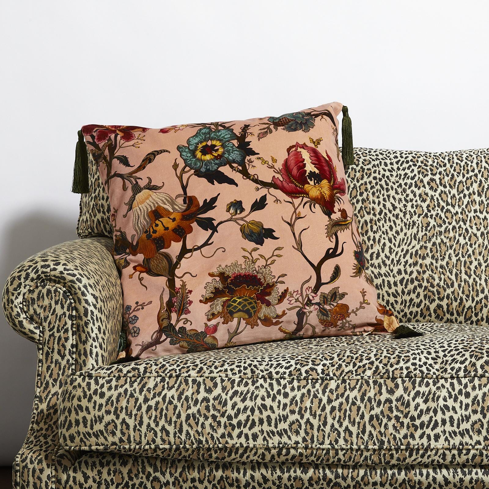 a couch with a floral pillow