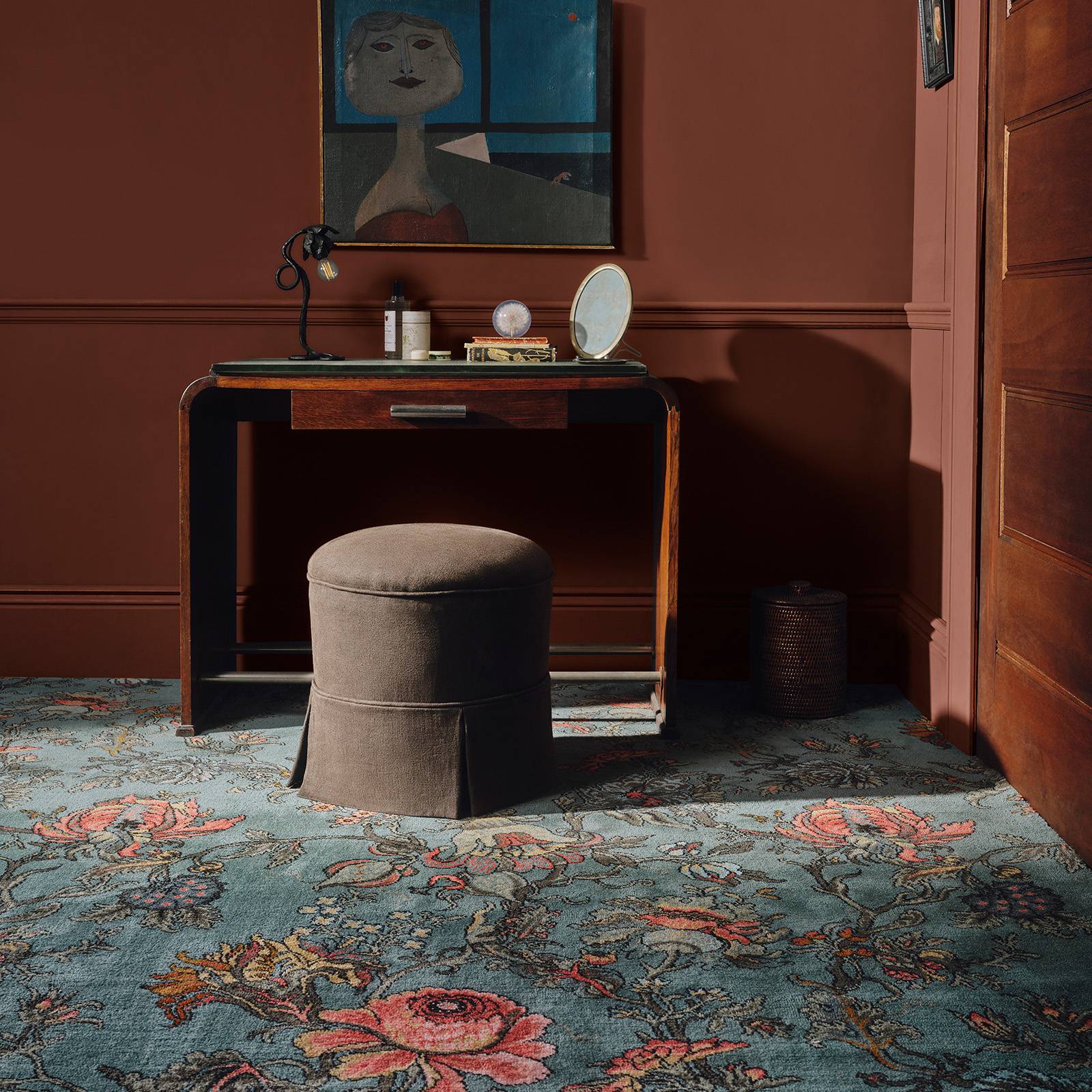 a room with a table and a painting on the wall