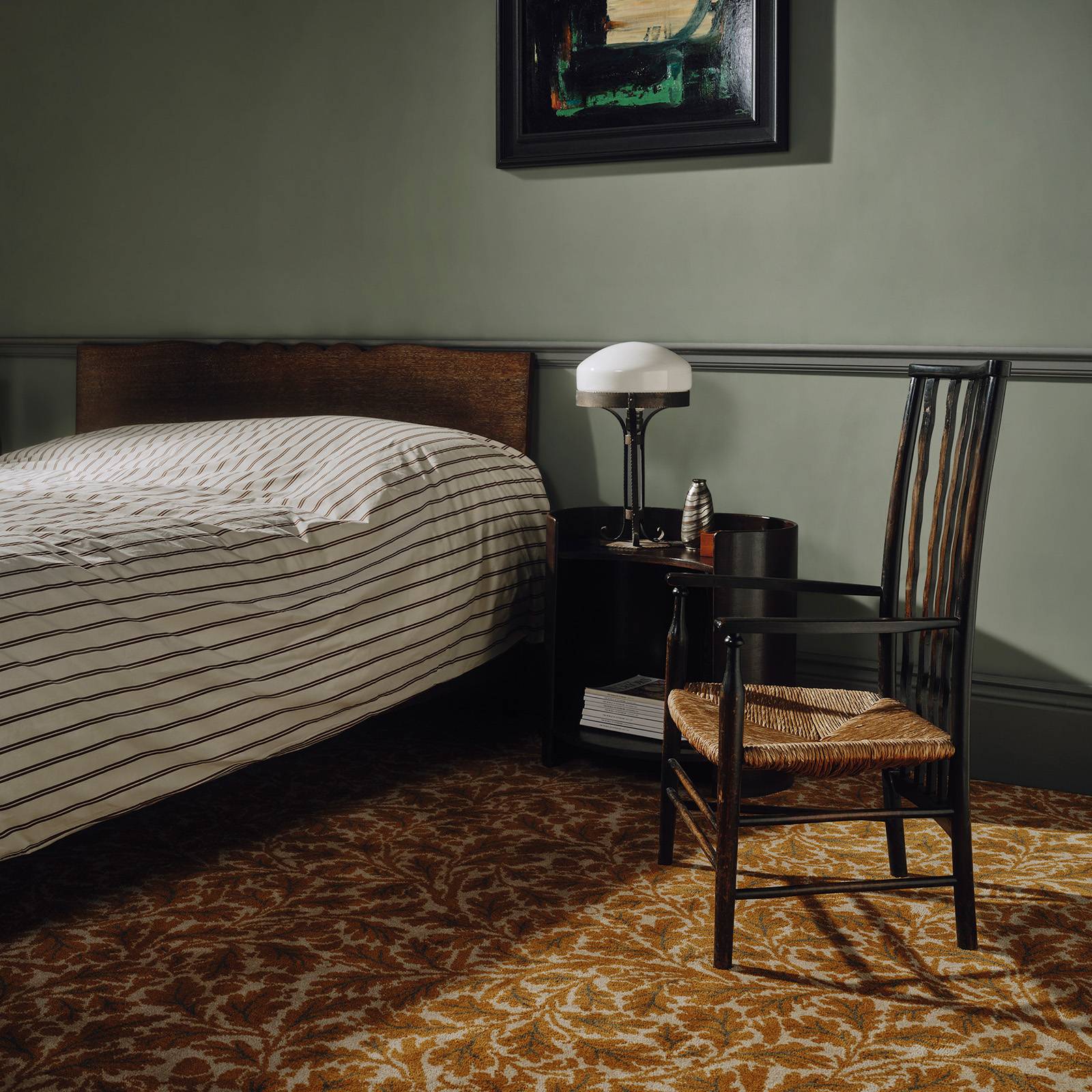 a chair next to a bed