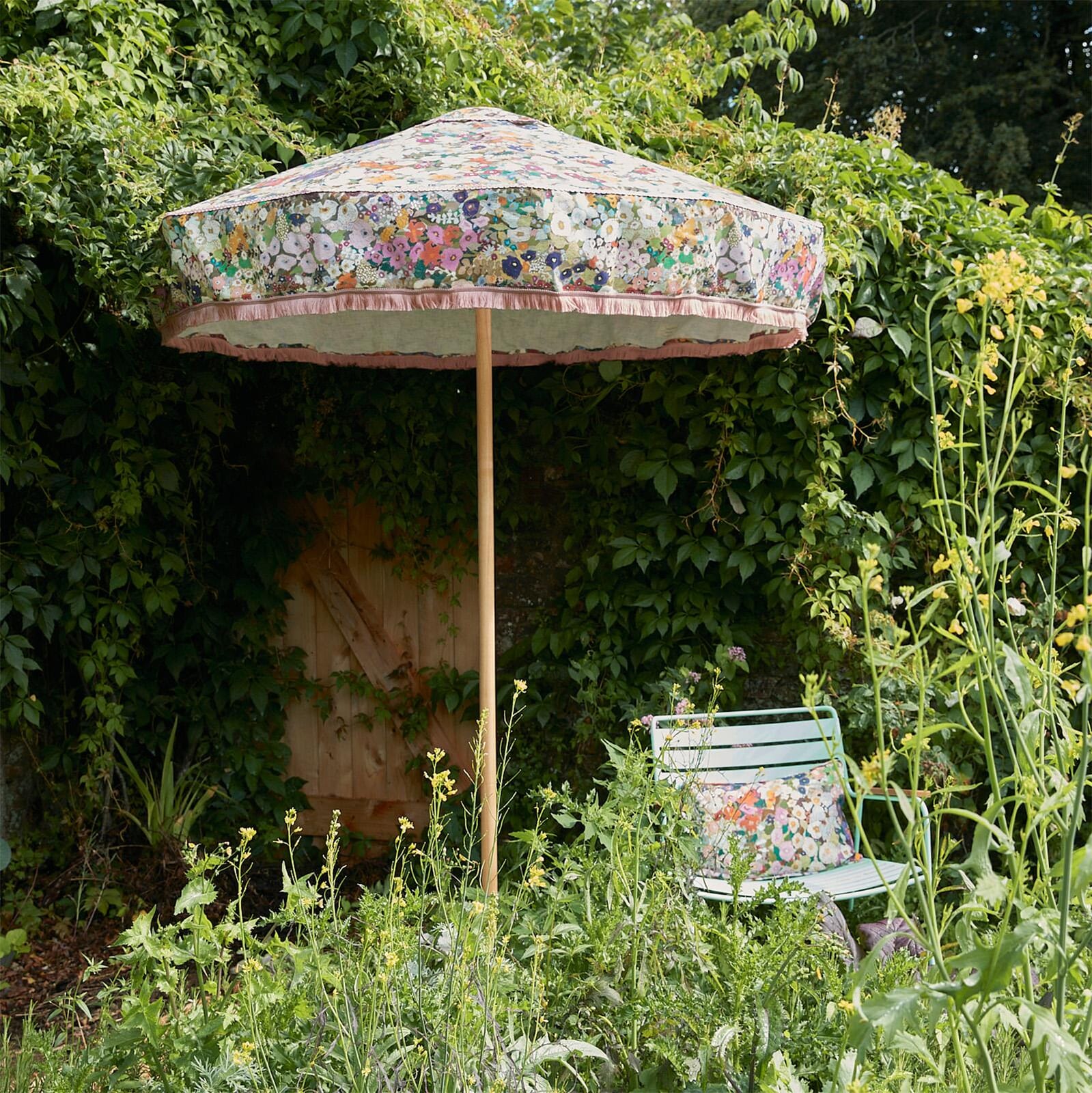 a chair and umbrella in a garden