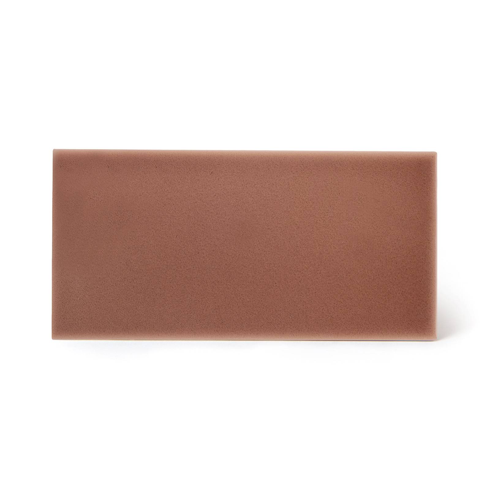 a brown rectangular object with a shadow